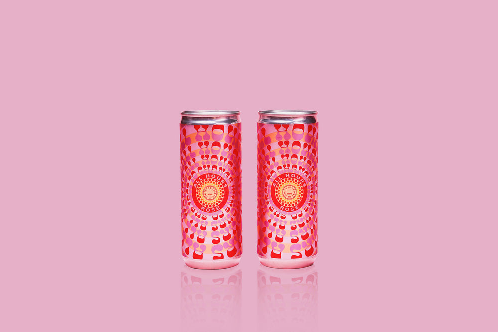 Two cans of 'All Hours' Rosé Cans on a Pink Background